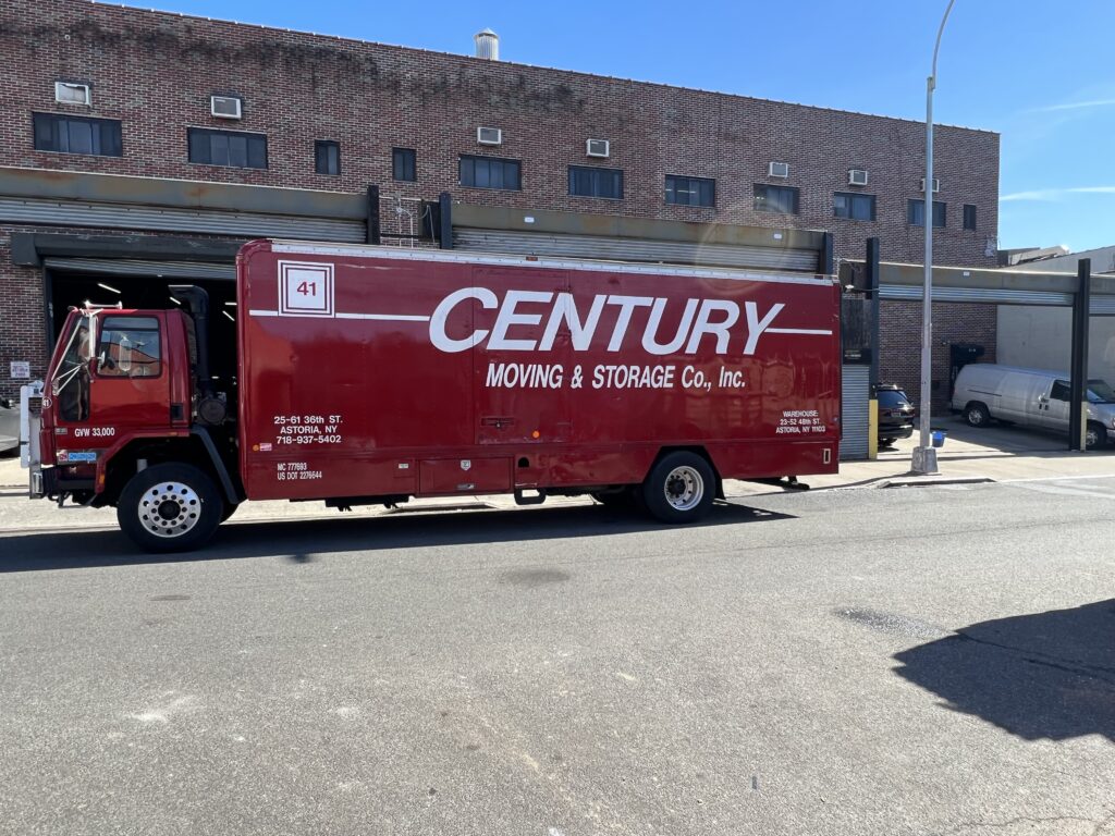 Century Moving & Storage Truck Parked Beside Lamppost